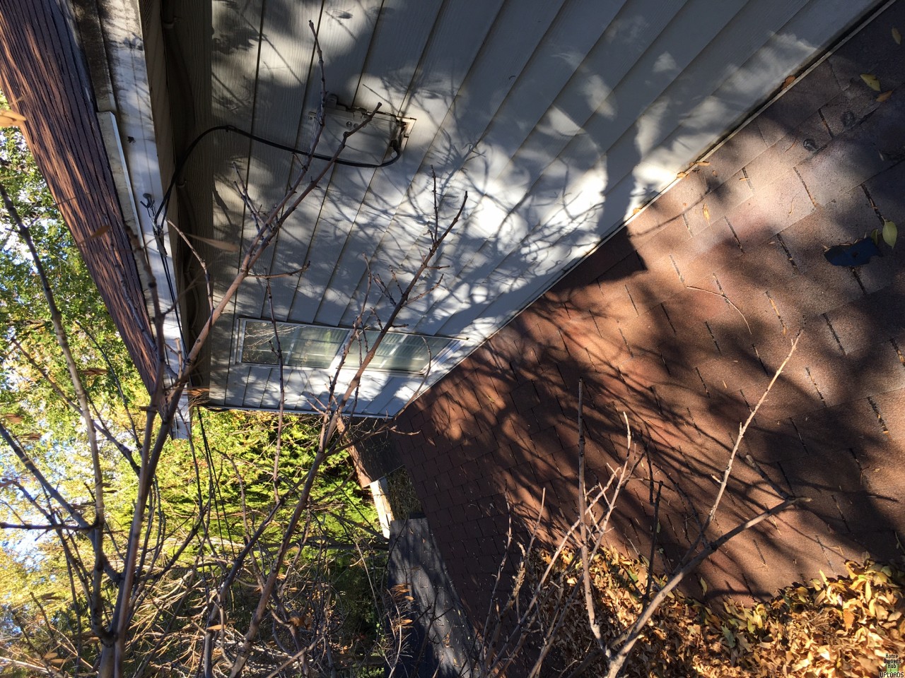 Image for Can I secure a ladder from a lower roof section to higher one? 