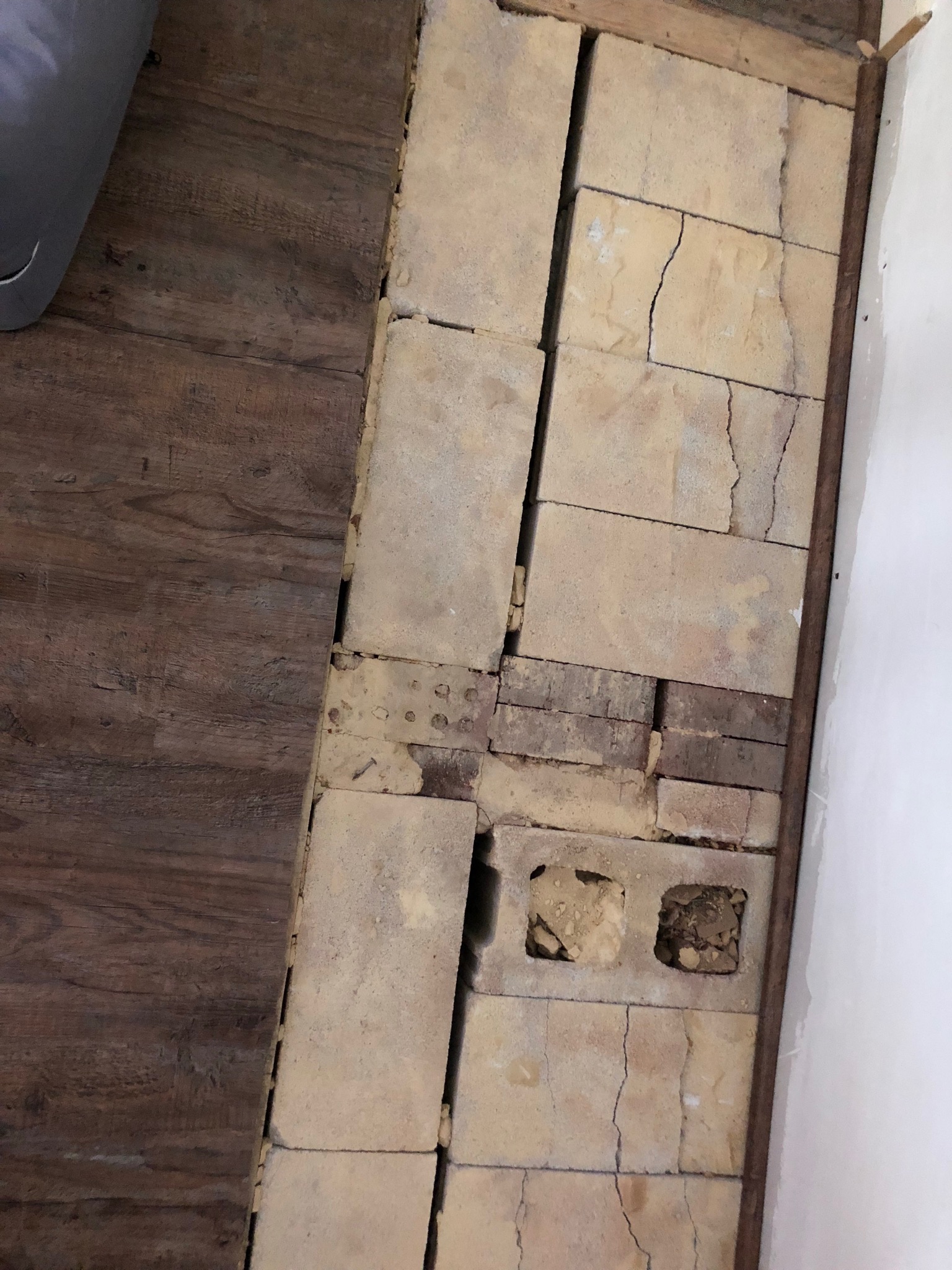 Image for How do I repair this mess under my removed fireplace hearth yo cove it with my lap flooring?